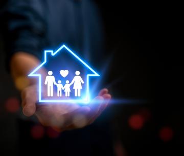 Un pictogramme fluorescent illustrant une famille et une maison